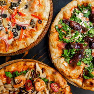 Tantalizing selection of gourmet pizzas with fresh toppings in Mexico City's vibrant dining scene.